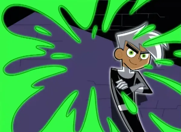 A screencap from the opening credits of Danny Phantom, with green glowing slime and a ghost boy in an action pose.